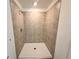 Tiled shower with chrome fixtures and a white shower pan, ready for relaxation at 7293 Eton Ln, Locust Grove, GA 30248