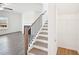 Interior staircase leading to the second floor, with a view of the living room at 7293 Eton Ln, Locust Grove, GA 30248