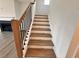 Staircase view with wooden treads and black metal railings at 7293 Eton Ln, Locust Grove, GA 30248