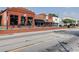 Street view of a charming brick commercial building featuring large display windows and awnings at 7293 Eton Ln, Locust Grove, GA 30248