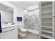 Bathroom with walk-in shower, modern vanity, and shelving at 505 Whitehall Sw St # 101, Atlanta, GA 30303