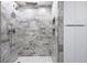 Large walk-in shower with gray marble tile, double shower heads, and built-in shelves at 505 Whitehall Sw St # 101, Atlanta, GA 30303