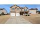 Two-story house with a three-car garage and a covered porch at 7705 Sylvaner Ln, Atlanta, GA 30349