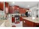 Well-equipped kitchen with granite countertops and dark wood cabinets at 7705 Sylvaner Ln, Atlanta, GA 30349