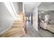 Elegant staircase with a beige carpet runner and wood railing at 7705 Sylvaner Ln, Atlanta, GA 30349