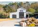 White barn with black doors and landscaping at 201 Edwards Brook Ct, Canton, GA 30115