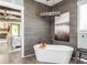 Relaxing bathroom with a freestanding soaking tub and wood-like tile at 201 Edwards Brook Ct, Canton, GA 30115