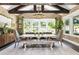 Bright dining room with rustic wooden table, exposed beams, and brick accent wall at 201 Edwards Brook Ct, Canton, GA 30115