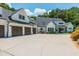 White farmhouse with dark brown garage doors at 201 Edwards Brook Ct, Canton, GA 30115