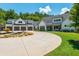 White farmhouse with circular driveway and landscaping at 201 Edwards Brook Ct, Canton, GA 30115