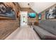 Game room with wood walls, a futon, and room for musical instruments at 201 Edwards Brook Ct, Canton, GA 30115