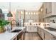 Modern kitchen with white quartz countertops, stainless steel appliances, and light wood cabinets at 201 Edwards Brook Ct, Canton, GA 30115