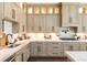 Spacious kitchen with light wood cabinets and herringbone tile at 201 Edwards Brook Ct, Canton, GA 30115