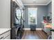 Convenient laundry room with front-load washer and dryer, and a butcher block folding counter at 201 Edwards Brook Ct, Canton, GA 30115