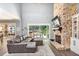 Living room with stone fireplace, high ceilings and view of backyard patio at 201 Edwards Brook Ct, Canton, GA 30115