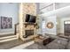 Living room with stone fireplace, hardwood floors and access to kitchen and upper level at 201 Edwards Brook Ct, Canton, GA 30115