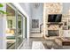 Living area featuring sliding glass doors opening to a patio, a large sectional sofa, and a stone fireplace at 201 Edwards Brook Ct, Canton, GA 30115