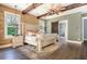 Main bedroom with exposed wood beams, exposed brick and an ensuite bathroom with glass shower at 201 Edwards Brook Ct, Canton, GA 30115