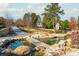 Landscaped pond with stone walkways and lush greenery at 201 Edwards Brook Ct, Canton, GA 30115