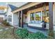 Porch with a comfortable swing bed and brick pavement at 201 Edwards Brook Ct, Canton, GA 30115