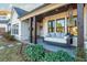 Covered porch with swing bed and brick flooring at 201 Edwards Brook Ct, Canton, GA 30115