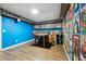 Finished basement room with wood floors, shelving, and comic book decor at 6820 Milbury Ct, Alpharetta, GA 30005