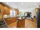 Open concept kitchen with island and view into Gathering room at 6820 Milbury Ct, Alpharetta, GA 30005