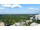 Aerial view of cityscape, featuring lush greenery and high-rise buildings at 34 Peachtree Ne Cir, Atlanta, GA 30309
