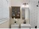 Clean bathroom with white vanity, subway tile, and glass shelves at 34 Peachtree Ne Cir, Atlanta, GA 30309