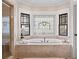 Luxurious bathroom featuring a soaking tub and stained glass window at 34 Peachtree Ne Cir, Atlanta, GA 30309
