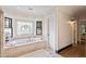 Spa-like bathroom with soaking tub and stained glass window at 34 Peachtree Ne Cir, Atlanta, GA 30309