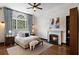 Bright bedroom featuring a fireplace and hardwood floors at 34 Peachtree Ne Cir, Atlanta, GA 30309