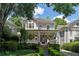 Two story home with wrap around porch and manicured landscaping at 34 Peachtree Ne Cir, Atlanta, GA 30309