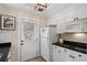 Small galley kitchen with white cabinets, black countertops, and microwave at 34 Peachtree Ne Cir, Atlanta, GA 30309