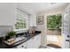 White kitchen with black countertops and direct access to deck at 34 Peachtree Ne Cir, Atlanta, GA 30309