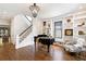 Living room with built-in shelving and grand piano at 34 Peachtree Ne Cir, Atlanta, GA 30309