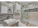 Updated bathroom with a walk-in shower and marble tile at 727 Charlotte Nw Pl, Atlanta, GA 30318