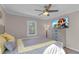 Bright bedroom with a queen bed, ceiling fan, and large TV at 727 Charlotte Nw Pl, Atlanta, GA 30318