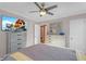 Bright bedroom featuring a queen bed, ceiling fan, and large TV at 727 Charlotte Nw Pl, Atlanta, GA 30318
