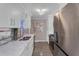 Updated kitchen with white cabinets, quartz countertops, and tile backsplash at 727 Charlotte Nw Pl, Atlanta, GA 30318