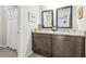 Bathroom featuring double sink vanity with dark wood cabinets and a walk-in shower with white shower curtain at 2090 Red Barn Ct, Cumming, GA 30040