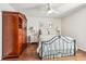 Charming bedroom with hardwood floors, comfortable bed, matching nightstands, and large armoire at 2090 Red Barn Ct, Cumming, GA 30040