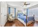 Bedroom with light blue bedding, hardwood floors, a ceiling fan, and natural light at 2090 Red Barn Ct, Cumming, GA 30040