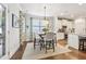 Cozy dining area with hardwood floors and decorative lighting is conveniently located off of the gourmet kitchen at 2090 Red Barn Ct, Cumming, GA 30040