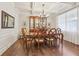 Formal dining room with hardwood floors, decorative chandelier, coffered ceilings, and large windows at 2090 Red Barn Ct, Cumming, GA 30040