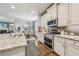 Open kitchen featuring stainless appliances, granite counters, island, and connection to the dining area at 2090 Red Barn Ct, Cumming, GA 30040