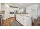 Bright kitchen with white cabinets, granite countertops, stainless steel appliances and wood floors at 2090 Red Barn Ct, Cumming, GA 30040