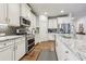 Well-equipped kitchen features stainless steel appliances, granite counters, subway tile backsplash, and white cabinetry at 2090 Red Barn Ct, Cumming, GA 30040