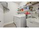 Laundry room featuring washer, dryer, utility sink, and shelving at 2090 Red Barn Ct, Cumming, GA 30040