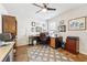 Bright home office with hardwood floors, ceiling fan, and built-in desk and shelving at 2090 Red Barn Ct, Cumming, GA 30040